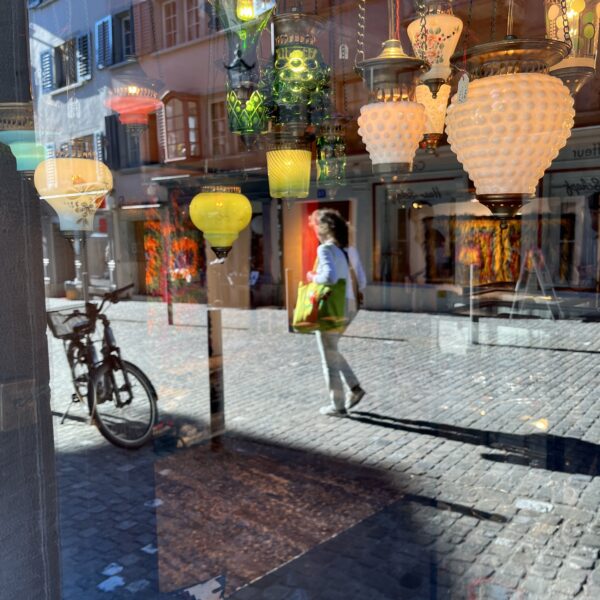 Nomadenschaetze: midday heat with young woman and reflections of Turkish lamps on the stones outside